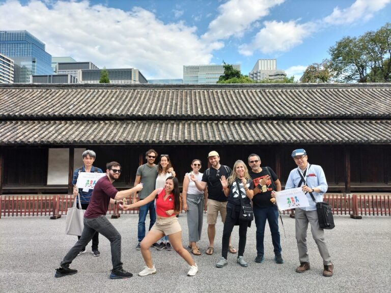 All the guests pose as ninjas with multiple guides at the Imperial Palace in Tokyo.