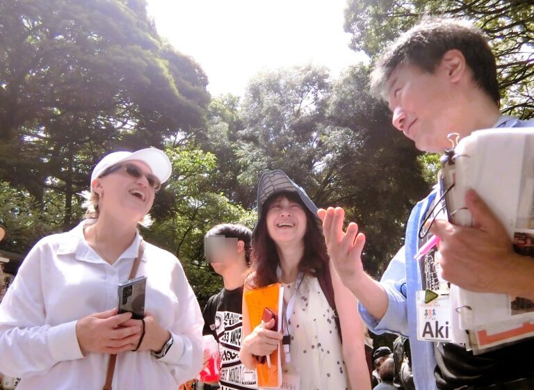 Laughing together, guides and guests at Meiji Shrine in Tokyo.