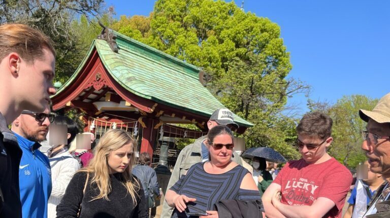 Five guests are listening to a story about Ueno, Tokyo, told by a guide from "Tokyo Free Walking Tour".